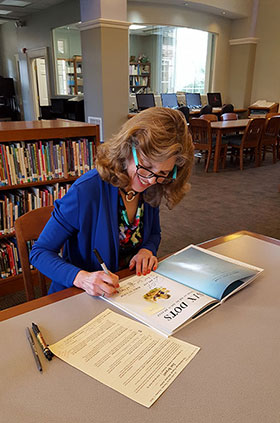 Jen signing Six Dots in the library